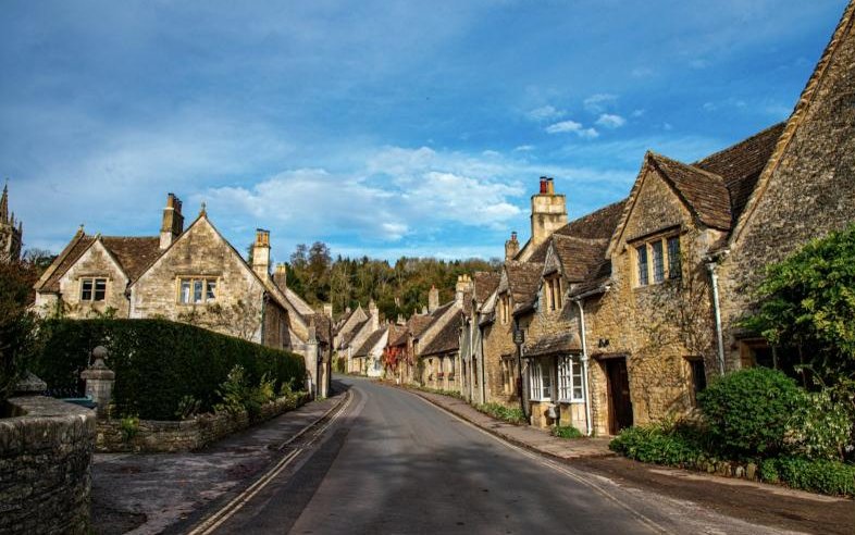 Honey-coloured stone cottages lining a quiet English village street